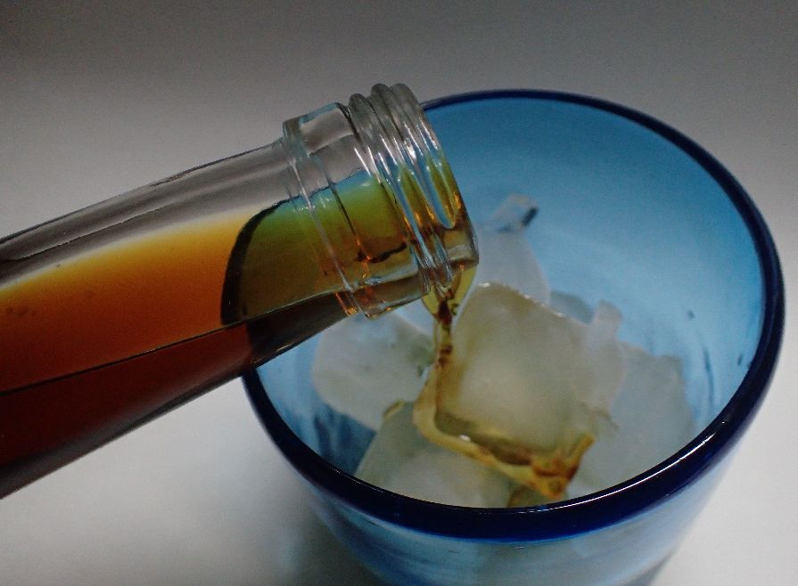 琉球ガラス・グラスに氷を入れて泡盛（コーヒー豆漬け）を注ぐ
